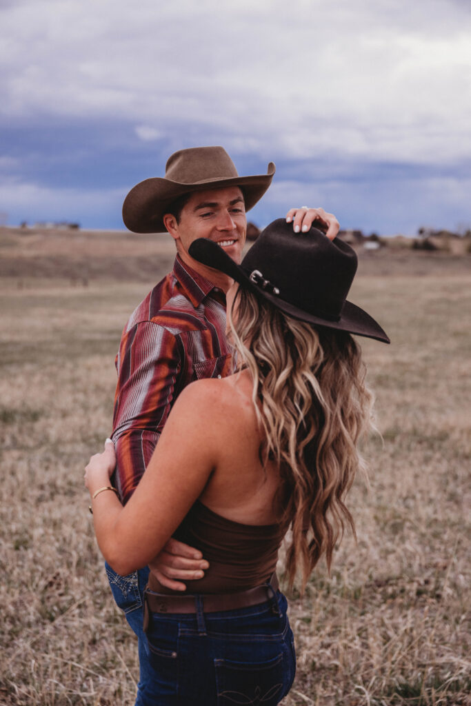 Swing dancing outdoors in a romantic couples session in Montana with storm clouds rolling in