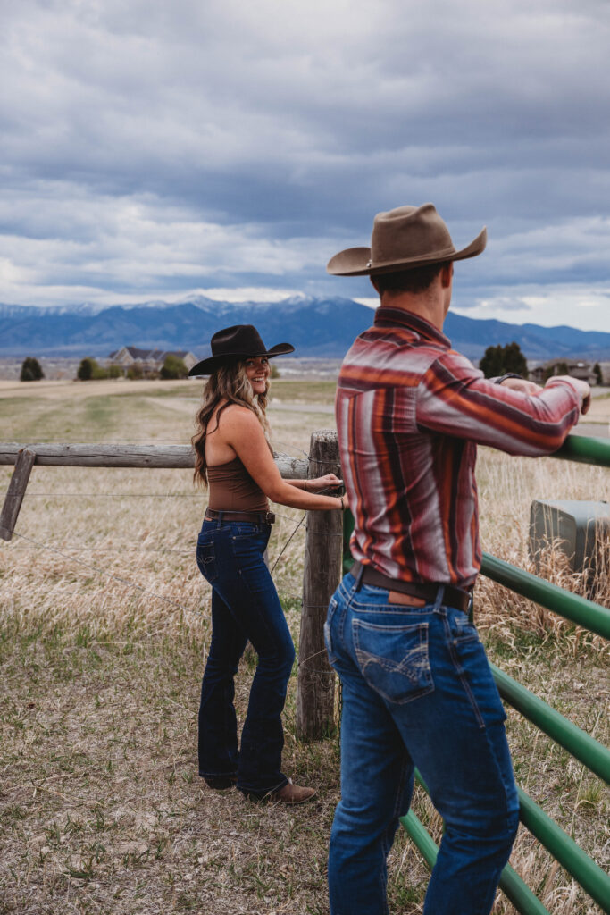 Montana Bridger Mountain Range and couple working the gate at the ranch