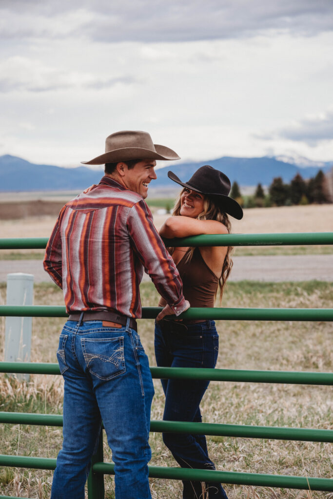 Couple having a romantic evening on the ranch for their photoshoot with the Bridger mountain range in the distance