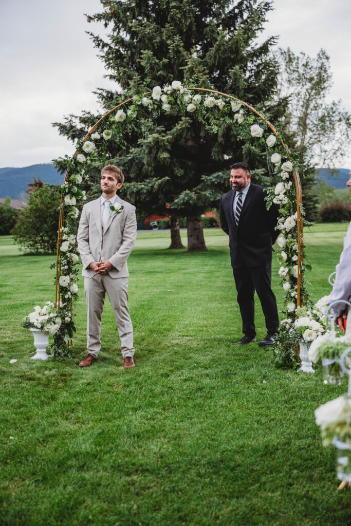 groom waiting patiently for his bride at the altar
