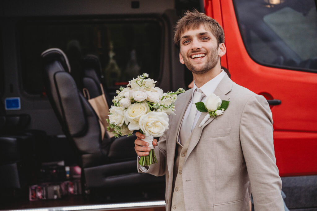 groom holding bouquet