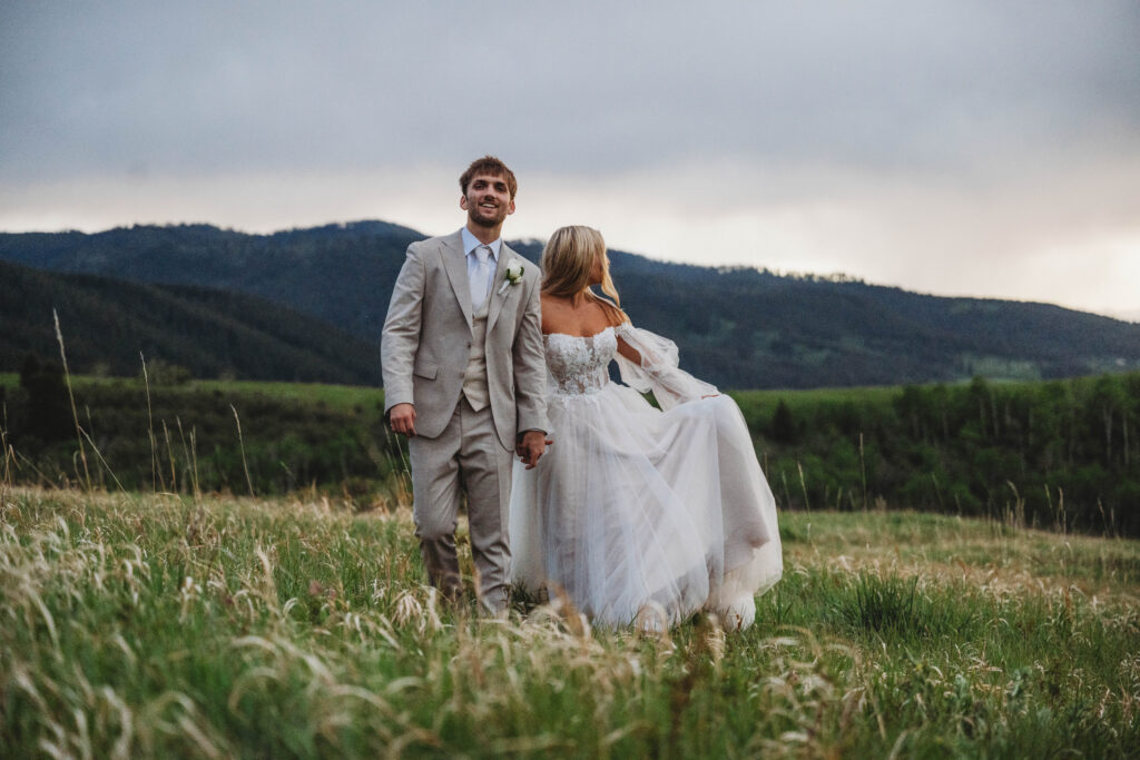 sunset portraits of a couple who just got married, enjoying the sunset and mountain views