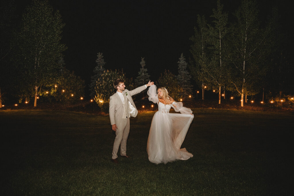 bride and groom dancing beneath the lights during a spring wedding reception near Bozeman, Montana